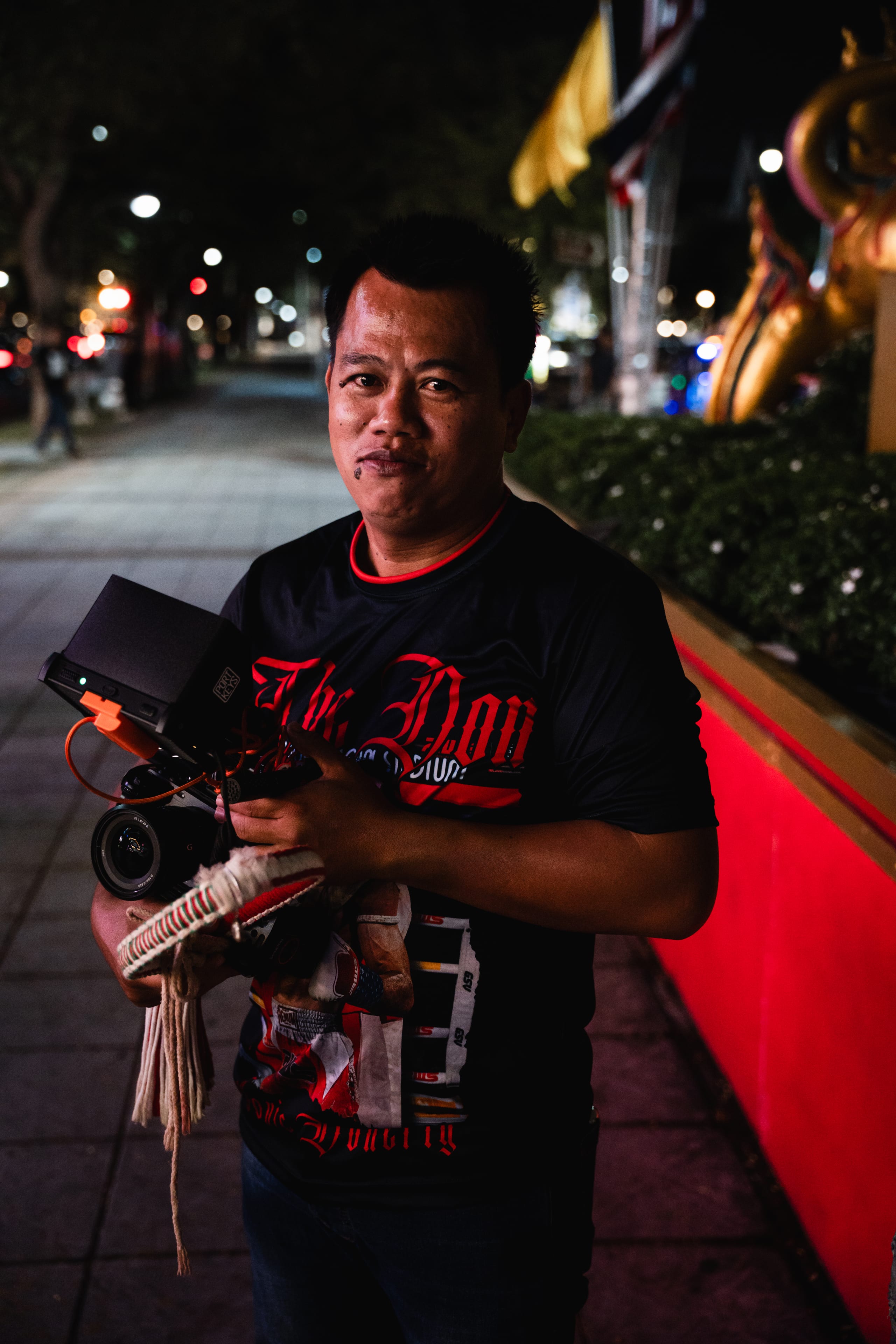 A cornerman carries the gear bag outside the stadium after the fight