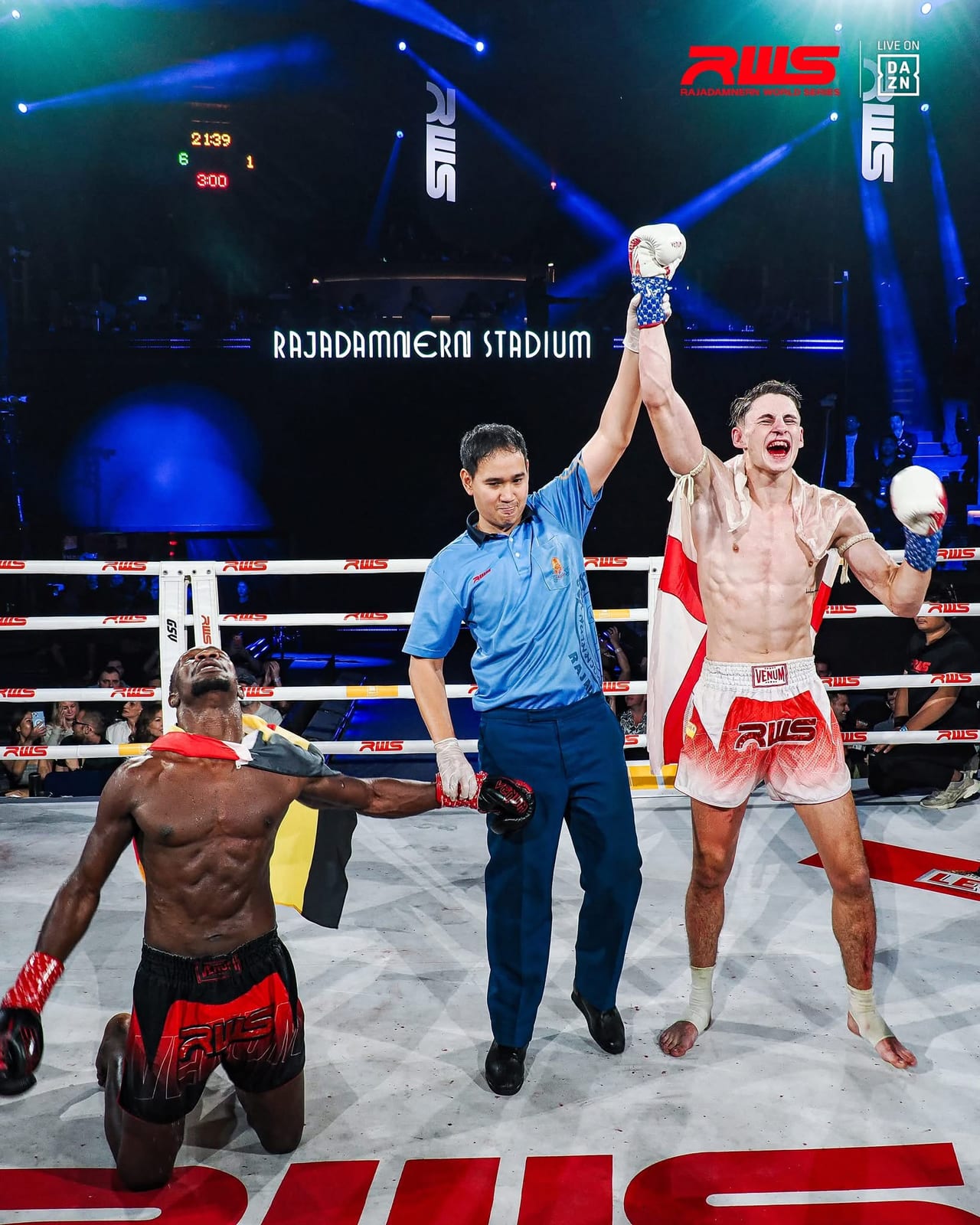 Louie Doherty has his hand raised at Rajadamnern Stadium as his opponent kneels