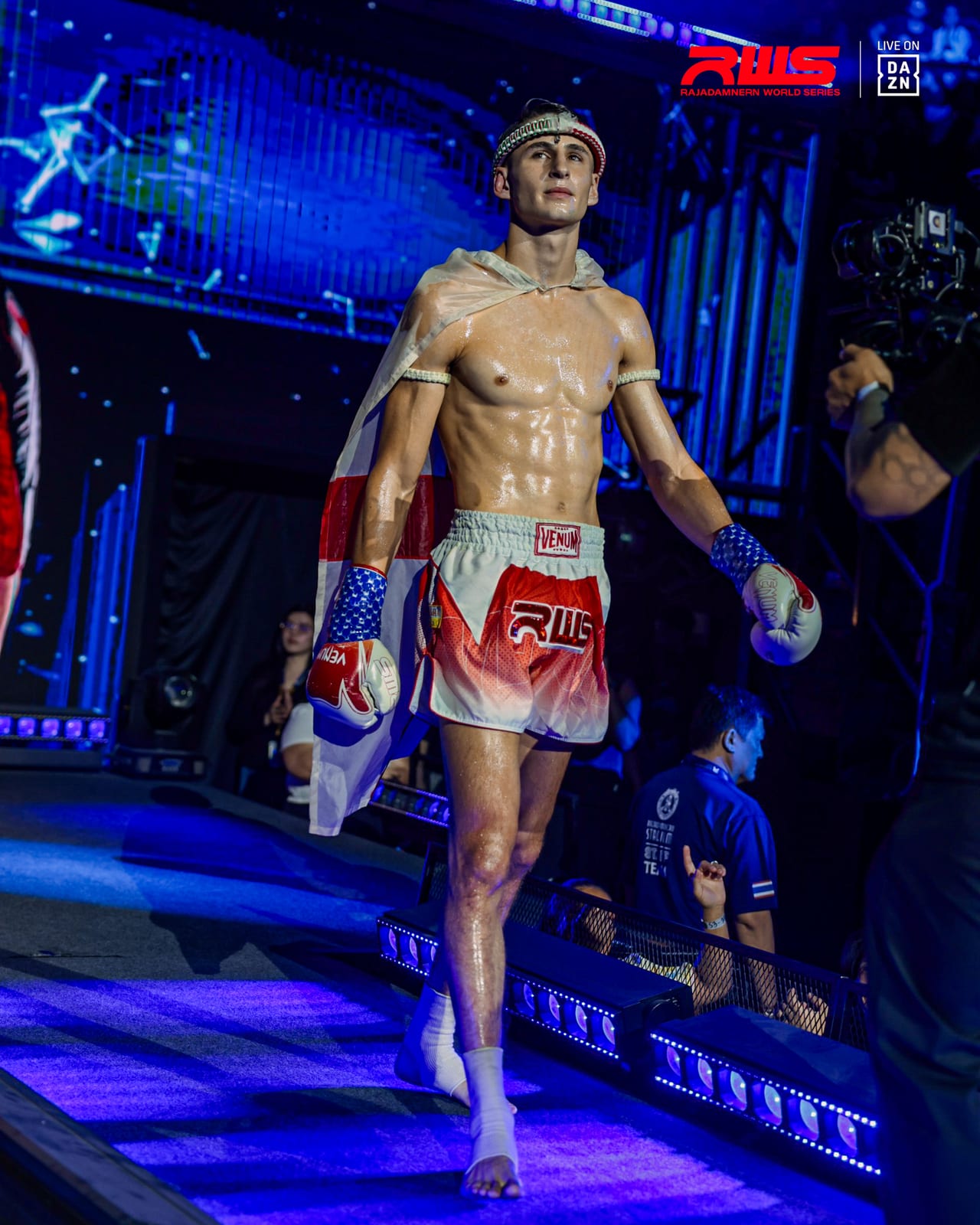Louie Doherty walking to the ring under blue stadium lighting