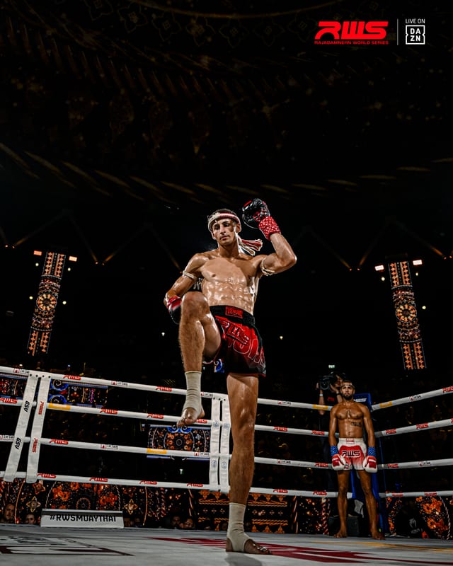 Wide view of the gold-lit stadium as Louie Doherty raises a knee mid-round